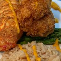 Fried Lobster Tail · Our fresh 6 oz fried whole shell lobster tail served with yellow rice pilaf & garlic asparag...
