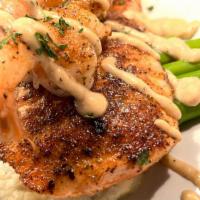 The District Double Surf · Wild-caught salmon grilled to perfection paired with grilled jumbo shrimp. Served over cream...