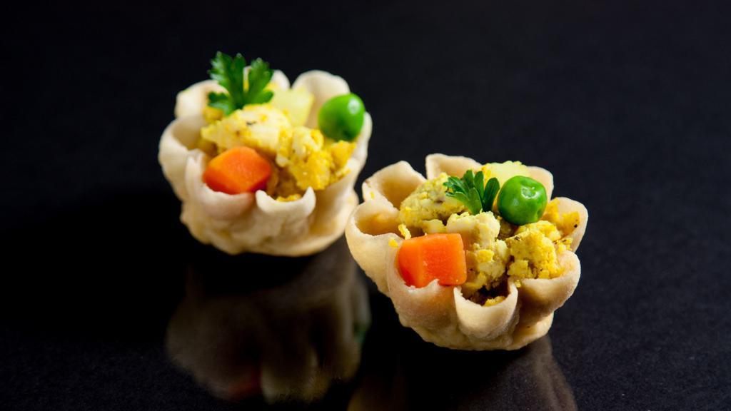 Curry Cup · Crispy mini cups filled with spiced minced chicken, potato, onion, carrot, peas and a cucumber dip.