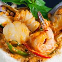 Island Treasures · A young coconut stuffed with shrimp, squid, mussel, scallop, bell pepper, basil, creamy curr...