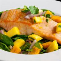 Summer Salmon · Pan-seared salmon fillet topped with refreshing Thai mango salsa on the bed of fresh baby sp...