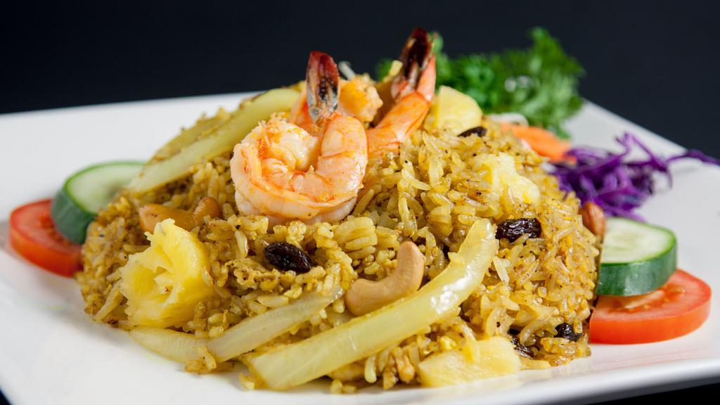 Pineapple Fried Rice · Fried rice with shrimp, chicken, egg, pineapple, onion, raisin, curry powder, cashew nuts.