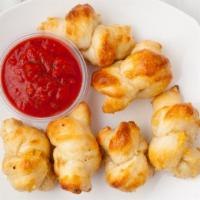 Garlic Knots · Fresh baked dough with infused olive oil wash with garlic and salt.