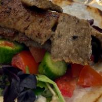 Gyro Wrap · Gyro meat, lettuce, tomatoes, cucumbers and onions wrapped in a gyro pita bed.