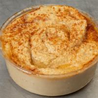 Hummus · Garbanzo beans, fresh garlic, and tahini blended together, topped with olive oil and paprika.