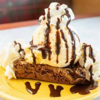 Brownie Sundae · Warmed house-made brownie topped with a scoop of vanilla ice cream, chocolate syrup and whip...