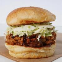 Pulled Bbq Chicken · Pulled BBQ chicken, sweet and tangy BBQ sauce, and. spicy slaw served on our freshly baked b...