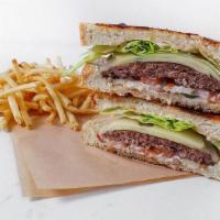 Grilled Sourdough Burger · Our sourdough bread grilled with garlic Parmesan. butter, grilled onions, Cheddar cheese, le...