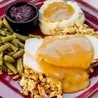 Traditional Roasted Turkey Dinner · Oven roasted turkey breast, homestyle stuffing, red skin. smashed potatoes, green beans*, ou...