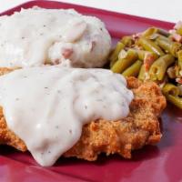 Chicken Fried Steak · Country chicken fried steak with country gravy, red skin. smashed potatoes, and green beans*.