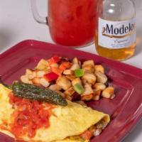 Fiesta Omelette · Mild green chiles blended w/ tomatoes, onions, jack & cheddar cheeses. Topped w/ Ms Polly's ...