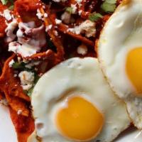 Chilaquiles · Freshly fried tortilla chips topped with green or red salsa, 2 eggs, sour cream & cheese.