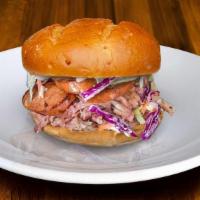 Sandwich-Spicy Pig · Built on a Potato Bun with ¼ lb. portion of Smoked Cajun Sausage that sits on a bed of Pulle...