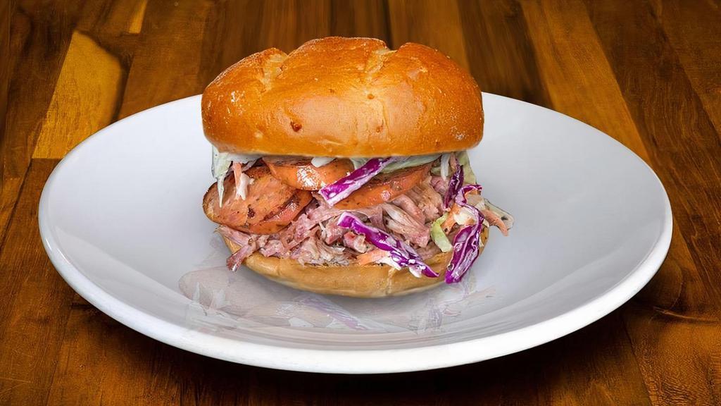 Sandwich-Spicy Pig · Built on a Potato Bun with ¼ lb. portion of Smoked Cajun Sausage that sits on a bed of Pulled Pork topped with our house-made Coleslaw.