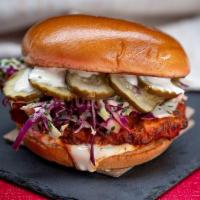 Buffalo Chicken Sandwich · country fried chicken breast tossed in buffalo sauce, slaw, lemon-herb mayo, pickles, brioch...