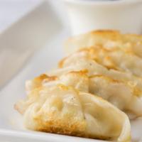 Potstickers · Pan fried chicken and vegetable pot stickers. Served with vinaigrette.