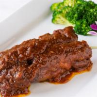 Honey Ribs · Pork ribs marinated in special BBQ sauce and perfectly grilled.