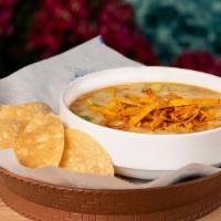Tortilla Soup  · A hearty soup with chicken, fresh vegetables, topped with jack cheese, avocado & tortilla st...