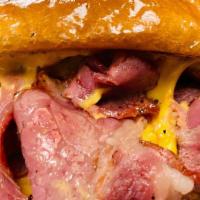 Champ #3 - Grilled Cheese Pastrami Sandwich · Slow Roasted Pastrami, Melted Cheddar Cheese on a Toasted Brioche Bun, Served with Waffle Fr...