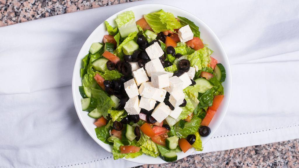 Greek Salad · Romaine lettuce, feta cheese, tomatoes, Persian cucumbers, olives, with our signature vinaigrette dressing.