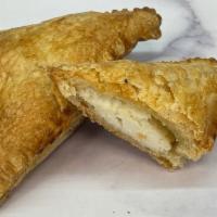 Feta Cheese Puff · Warm, flaky pastry dough stuffed with feta cheese.
