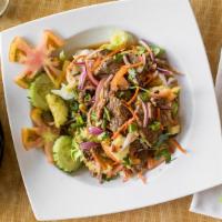 Beef Salad · Sliced grilled beef with onions, tomatoes and cucumber in a spicy lime dressing. Hot and spi...