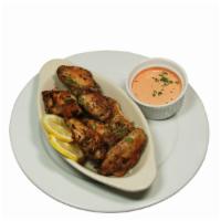 Classic Chicken Wings · Crispy bone-in chicken wings tossed in your choice of sauce. Served with a spicy red pepper ...