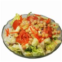 Tossed Green Salad · Iceberg lettuce, red cabbage, wedged tomatoes, cucumbers, shredded carrots and garbanzo bean...
