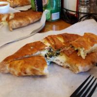 Spinach Calzone · Pizza dough folded and stuffed with ricotta cheese, mozzarella cheese, spinach. Oven baked. ...