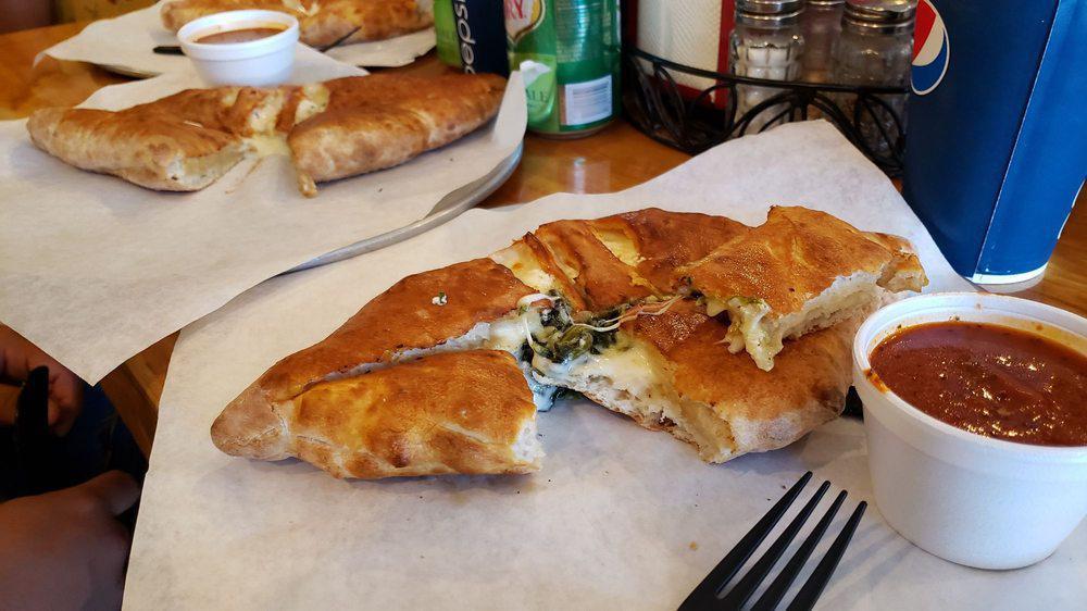 Spinach Calzone · Pizza dough folded and stuffed with ricotta cheese, mozzarella cheese, spinach. Oven baked. Served with marinara sauce.