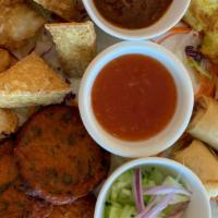 Thai Mango Sampler · Chicken satay, fish cake, coconut shrimps, crispy tofu and fried spring rolls.