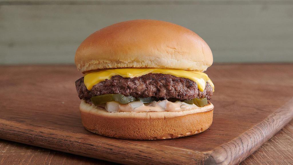 1/3 Lb Natural® Cheeseburger · In 2012, we were the first to introduce the Natural®. Still naturally delicious, this fresh, never frozen 1/3 lb. pure beef patty is made from beef raised without antibiotics and no added hormones ever. It's topped with 2 slices of American cheese and served with diced onion, house-made 1000 island dressing, and dill pickles on a locally baked toasted brioche bun. Nothing between you and cheeseburger bliss.