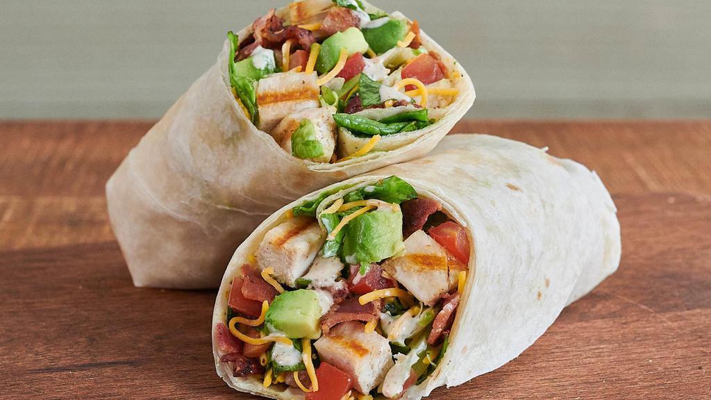Farmer’S Chopped Cobb Wrap™ · Grilled all-natural chicken breast, hand-diced Hass avocado, hickory-smoked bacon, shredded cheddar cheese, diced tomato, and farm fresh greens tossed with house-made ranch dressing and wrapped in a warm flour tortilla.