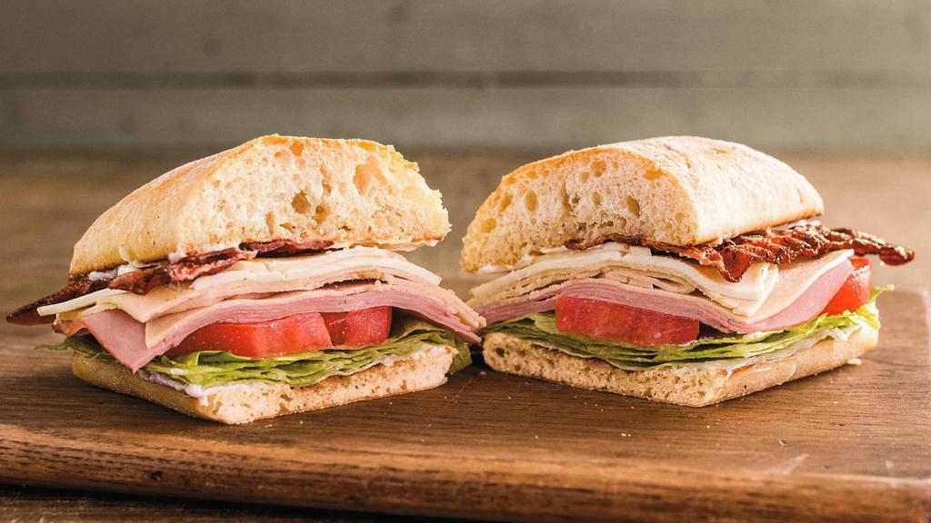 Farmer'S Club Sandwich ™ · Locally baked La Brea ciabatta, piled high with sliced ham and turkey, hand-sliced tomato, crisp lettuce, cheese, Italian dressing, mayonnaise, and topped with thick hickory-smoked bacon. This is the Club you really want to get into.
