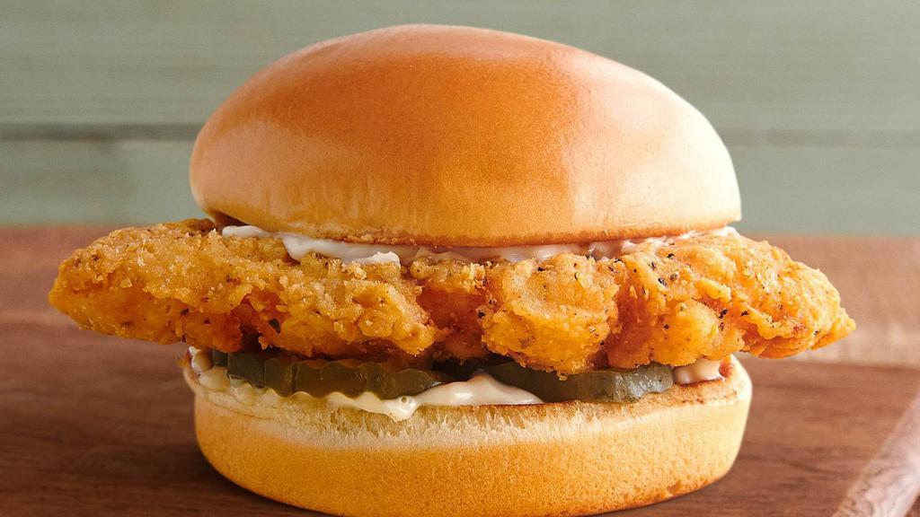 Classic Fried Chicken Sandwich · An all-natural chicken breast, double-battered for extra crispiness and seasoned with our proprietary blend of spices, and fried to crispy perfection. It's served with mayonnaise and dill pickles on a locally-baked toasted brioche bun.