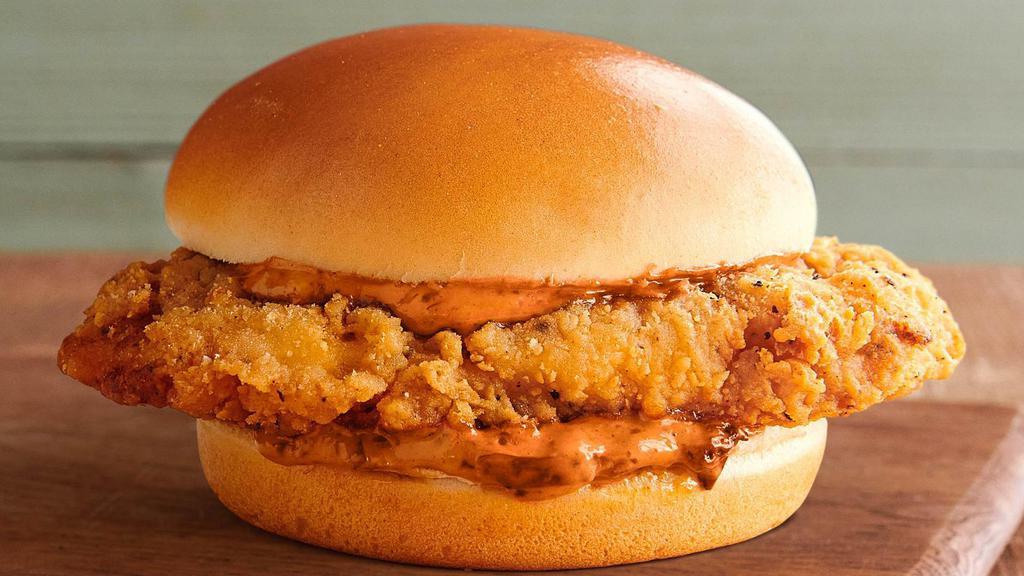 Fiery Fried Chicken Sandwich · An all-natural chicken breast, double-battered for extra crispiness and seasoned with our proprietary blend of spices, and fried to crispy perfection. It's served with our house-made Fiery Farmer's Sauce on a locally baked toasted brioche bun.