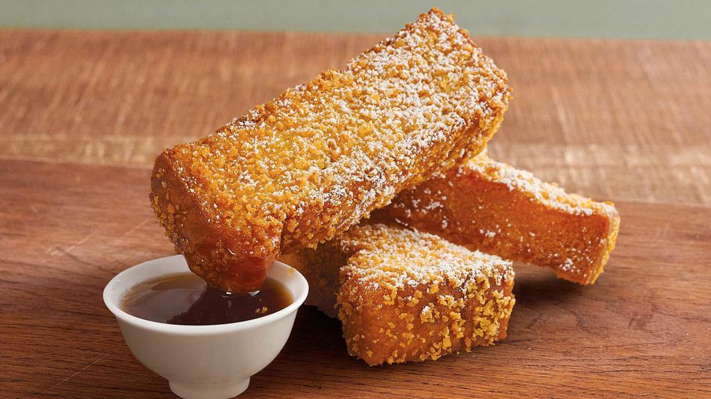 Crispy French Toast Dippers · 3 freshly battered and cooked up crispy locally baked bread sticks, dusted with cinnamon, powdered sugar, and served with maple-flavored syrup.