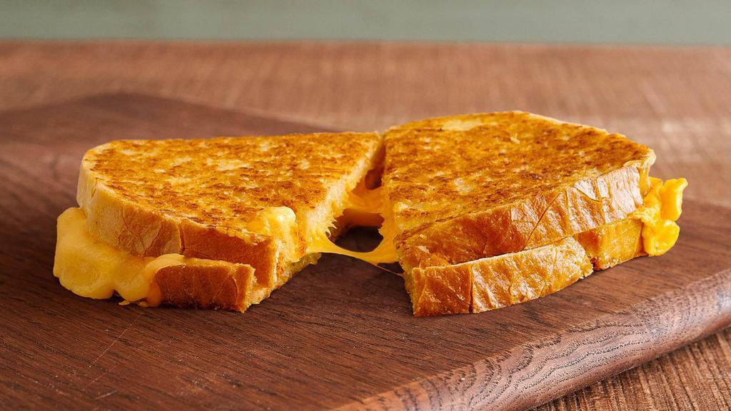 Parm-Crusted Grilled Cheese · Locally baked sourdough, loaded with 3 slices of melted American and pepper jack cheese and grilled with a crispy and tasty Parmesan crust.