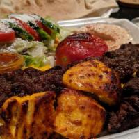 Combo Plate · Three pieces of beef and chicken and one skewer of luleh with rice, a green salad, hummus, g...