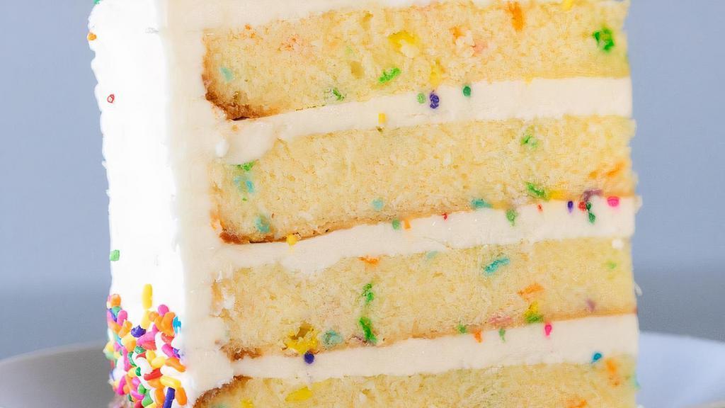 Vanilla Confetti Cake Slice · Vanilla cake with a burst of rainbow sprinkles filled and iced with a sweet buttercream icing.