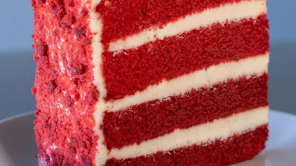 Red Velvet Cake Slice · Red velvet cake filled and iced with cream cheese frosting. Decorated with red velvet cake crumbs.
