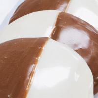 Black & White Cookie · Soft, cake-like cookie covered half and half with vanilla and chocolate icing.