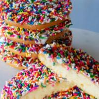 Vanilla Rainbow Cookie · Soft cake-like cookie covered in vanilla icing and rainbow sprinkles.