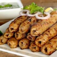 Chicken Seekh Kebab (4) · Ground chicken perfectly mixed with onions and freshly roasted spices, bbqed in tandoor.