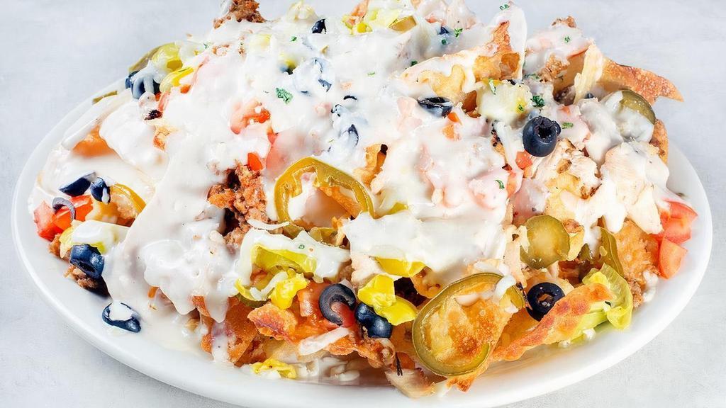 Italian Nachos · Crispy pasta chips, black olives, pepperoncinis, Roma tomatoes, jalapeños, Alfredo sauce, Mozzarella and Parmesan. Your choice of Chicken, Sausage, or Combo.