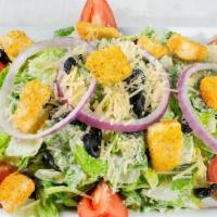 Classic Caesar Salad · Fresh romaine, Roma tomatoes, black olives, red onions, Parmesan and garlic croutons in a Ca...