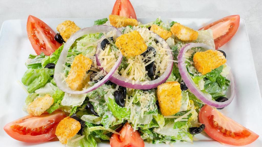 Classic Caesar · Fresh romaine, Roma tomatoes, black olives, red onions, Parmesan and garlic croutons in a Caesar dressing.