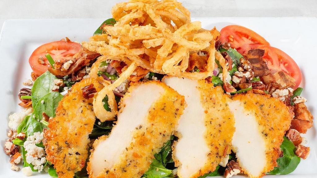 Pecan Chicken · Fresh spinach, Gorgonzola, Roma tomatoes, applewood smoked bacon, red onions, candied pecans, and crispy onion straws tossed in a warm bacon vinaigrette. Topped with our handmade chicken Parmesan.