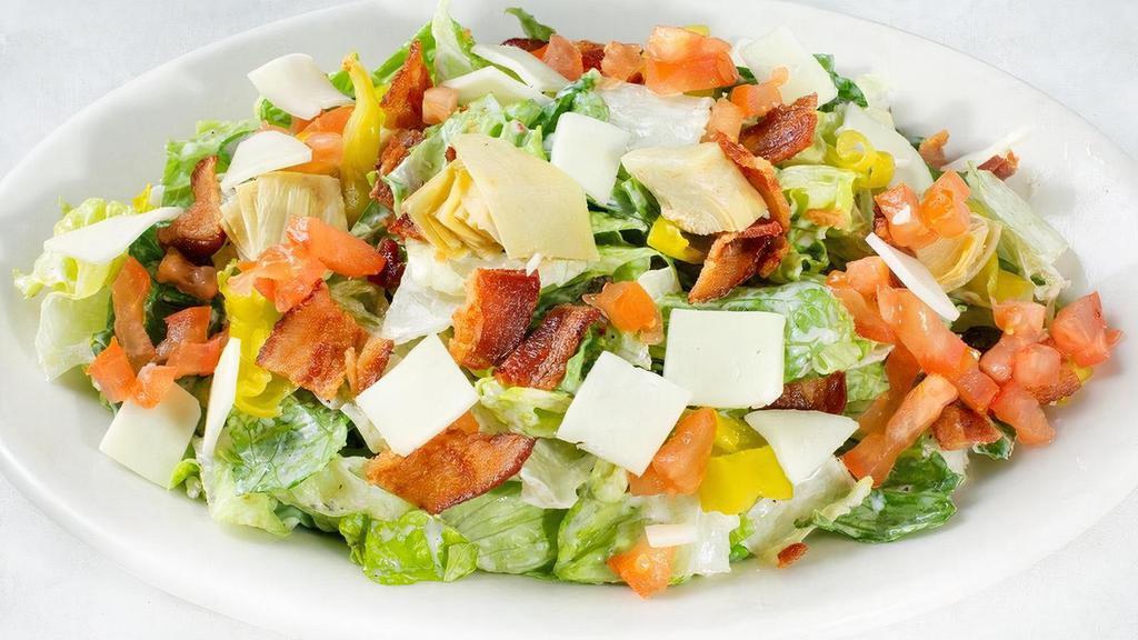 Johnny'S Chopped  Salad · Chopped romaine tossed in Italian vinaigrette and ranch dressing. Topped with applewood smoked bacon, Roma tomatoes, pepperoncini, red onions, Mozzarella cheese and artichokes.