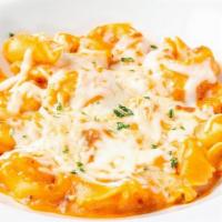 Baked Cheese Tortelloni · Cheese stuffed tortelloni with a creamy meat sauce. Baked with Mozzarella and Parmesan.